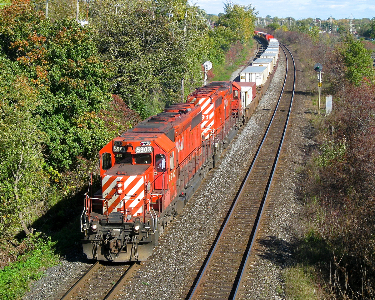 Setting the not-so-wayback machine to 2010, we see a pair of CP SD40-2's (CP 5903 & CP 5991) heading west through Beaconsfield with an intermodal train. Since then SD40-2's have become much rarer on CP and the searchlight signals in the background have been replaced.