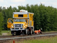 Something needs attention! Sperry Rail Services MOW vehicle SRS 935 is stopped on the main line at Ardrossan while the crew is out looking at the tracks.