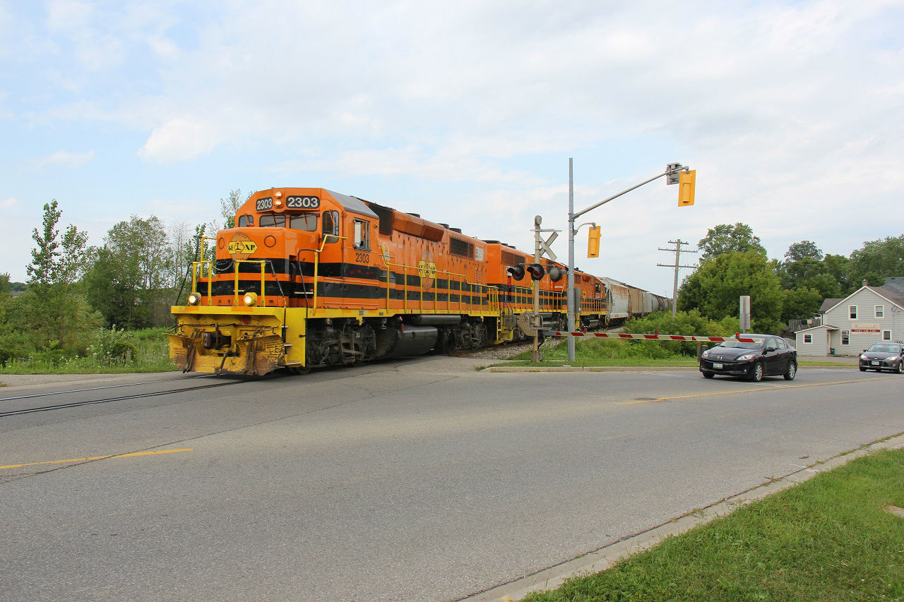 GEXR train 518 heads west towards Stratford after working Kitchener. Today's power features a trio of G&W orange and yellow locomotives - GEXR 2303, GEXR 3030 and QGRY 2500. Time - 15:47.
