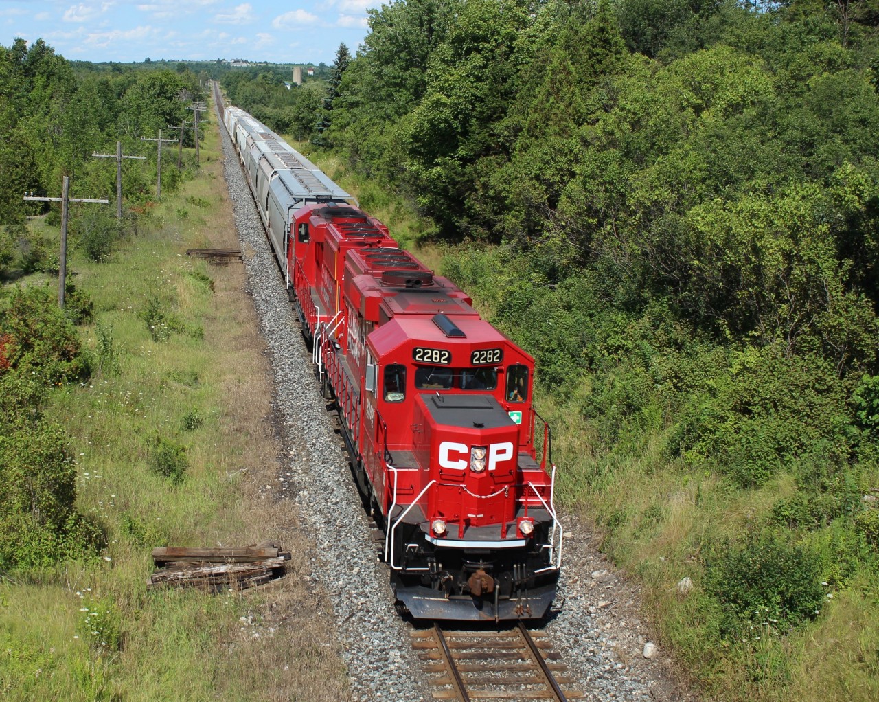 An exceptionally clean CP 2282 leads CP 2257 up to the Highway 6 overpass at MM 44.9 on the Galt sub heading west cleared to Wolverton with a small load of hopper cars.