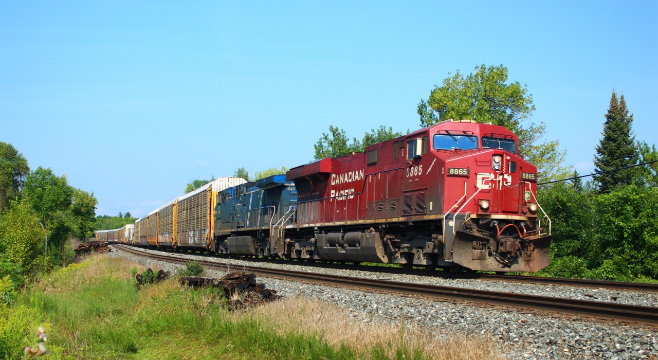 CP 8865 leads CEFX 1048 up to the Tremaine Road crossing on the Galt sub. with its manifest of auto racks and mixed freight.