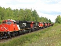 A sextuplet of newly delivered, and soon to be delivered locomotives, reaches MM30 on the Halton sub on a cloudy afternoon, with CN 3000 leading  CN 3001, CN 3008, CN 3009, CN 3005 and CN 3003 hauling a mixed load of freight.