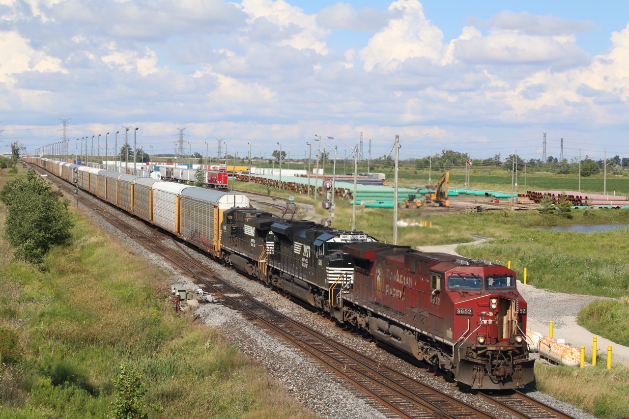 CP train 147 has a pair of NS units trailing as it storms past the "Expressway" yard at Hornby.