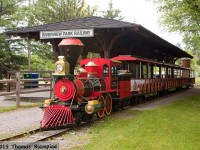 As part of its commitment to the city, the Peterborough Utilities Commission operates the Riverview Park Zoo, including the ever-popular miniature railway, which uses a gasoline-powered locomotive to pull the train across the Otonabee River on a short loop of narrow-gauge track. The train is seen at the Riverview Park station before the first trip of the morning.