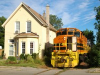 RLHH 3049 passing between #10 and #12 Port Street on the way to Ingenia with six hoppers