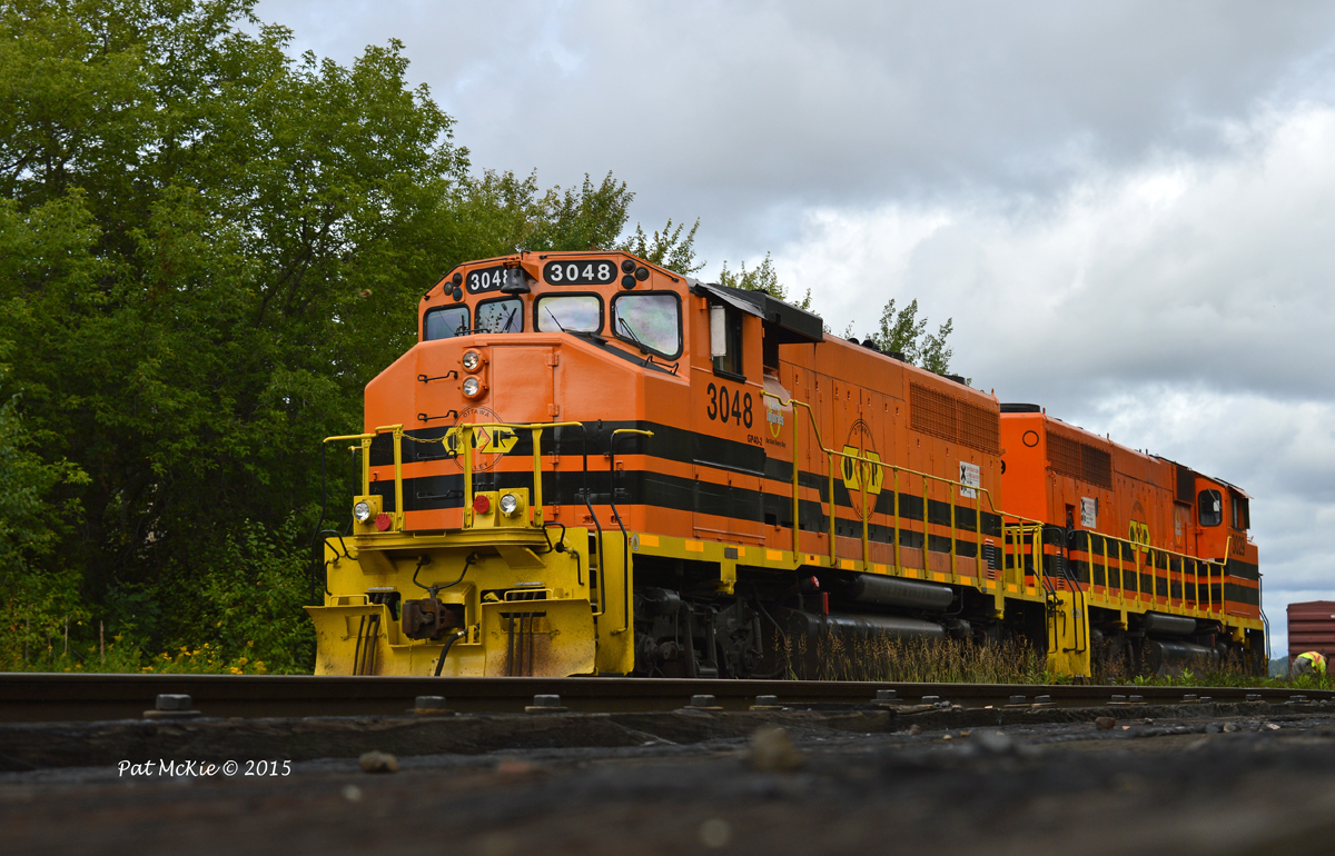 OVR 3048 & 3029 work the yard crossing the small creek as they build the east bound train on an overcast & rainy day