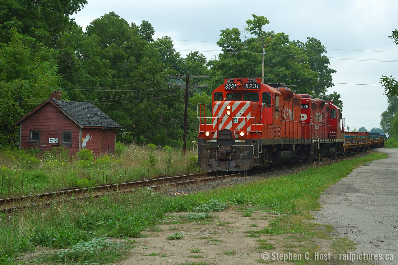 And a photo that has aged well - many of these things are no longer possible - GP9's on CP? Nope. The frame train? Gone. That building at left - gone. Question is - what was it? It is clearly a railroad structure and quite old at that.. I'd bet it dates to the Credit Valley Railway though! 
Sometimes it's best to hold onto your shots - in time they do age and eventually, your 'dreary crummy day shot' can turn into gold if you wait long enough.
In this photo, this is Train 141, the daily frame train - which is now on the St. Thomas Sub headed for St. Thomas. The frame train was an interesting thing - in 1997/8 CP put the St. Thomas sub on the block due to lack of traffic, but in 1999 they won a contract from GM to run frames from Formet (Magna) in St. Thomas to the GM Truck plant in Oshawa. CP had to become creative - as in doing this, two crews would be required due to crossing terminals (from London Division to Toronto Division) and an exception was granted by the Union to allow a single crew to man the train - which was the London Division that crewed it. The train ran seven days a week and was very predictable - it was one of the hottest trains on the line. Due to this, crews loved the train as you were working basically, days, home at regular times, and in order to hold this job, you basically needed to be top of the seniority list. Jeff Willsie was one of the men that held this job. Only until this frame traffic dwindled did CP re-activate the shortline plans - bringing us to OSR's operation today. Also interesting, around this time, in the event of major derailments on the CP or CN - this connecting track would be used to detour trains back to/from CN or CP - anyone shoot re-routes here? I never did!
So youngins - your lesson is things change - and fast. This is only 10 years ago. :) Get your shots, things will continue to change as they always have :)