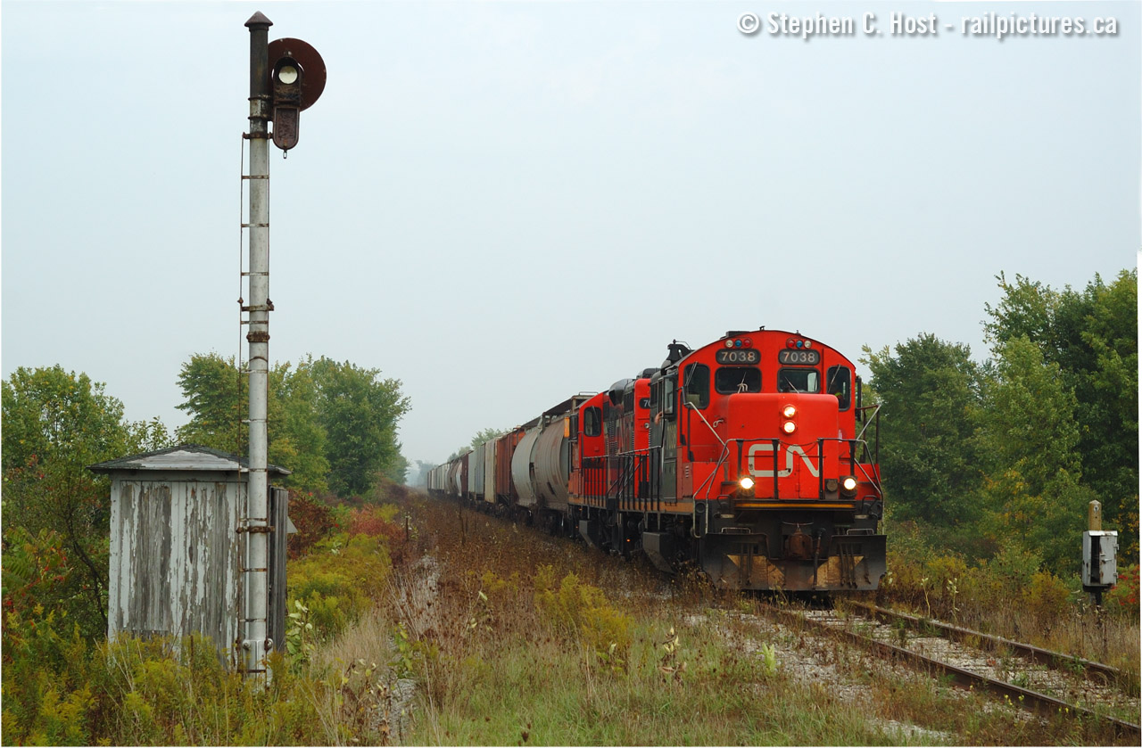 Back to my oldies.. Here we have CN 513 heading west near Shedden Ontario. I was departing London after my "stag night"  with a pounding headache (I wonder why!) and heard the OCS clearance on the St Thomas sub for 513 who was heading to the elevator at Rodney, mile 153 or so. The chase was on - my one and only shot at photographing a train on the CASO between St Thomas and Fargo - at this time CASO trains from St Thomas ran once a week with about 20 to 30 cars. A real shame they couldn't just run to Rodney from Chatham - why they abandoned it in this manner is beyond me, but given how the CASO was handled it's no surprise.