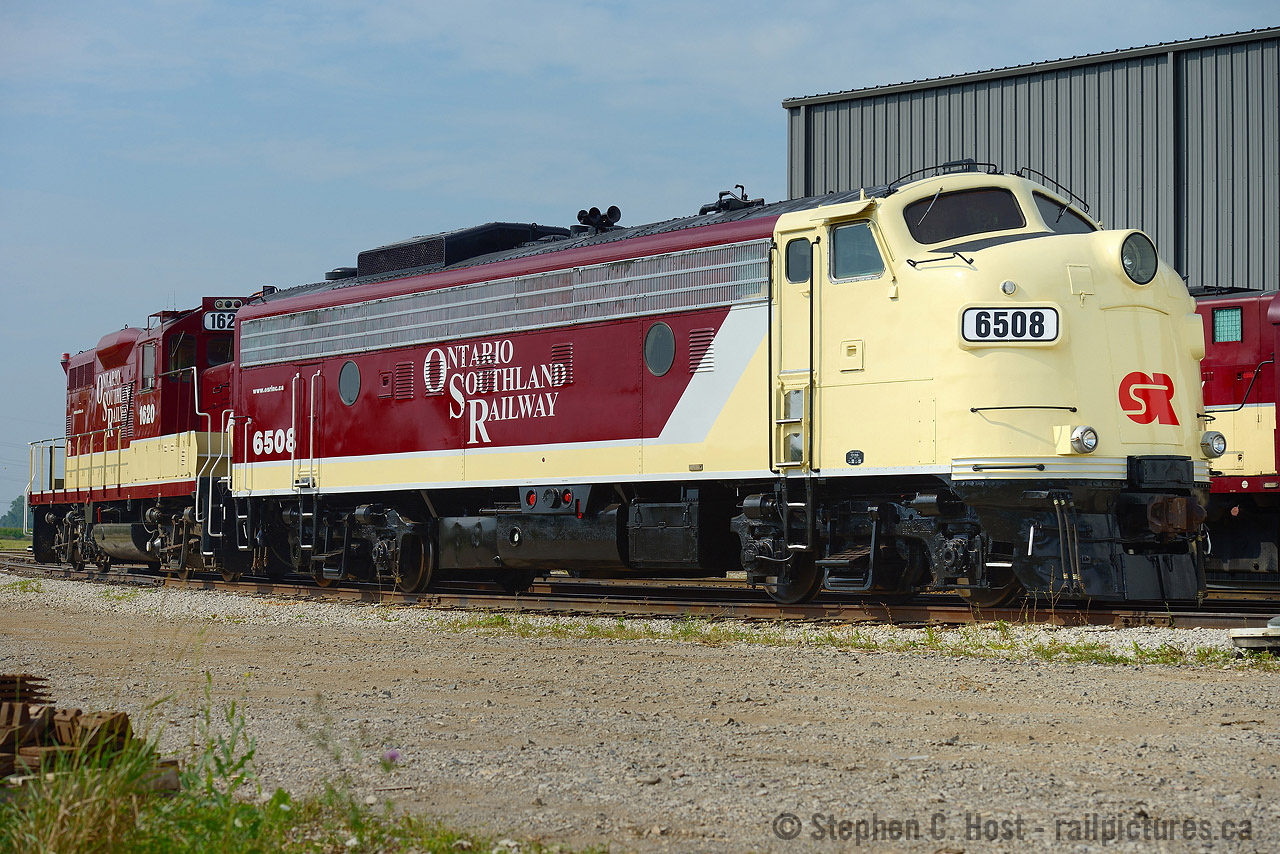 Bob Merriam's hard work basks in the sun at Salford - both 1620 and 6508 bearing his mark. Bob is an OSR mechanic who has a speciality in designing and repainting engine schemes - and has repainted OSR engines for the last 10 years or so. 1620 was the first engine repainted for OSR since 2007, and 6508 followed soon after the completion of 1620. Why in this order? Well, to start, 1620 was bought from CP, and the CP branding has to come off. By the time the branding was taken off so much of the engine was in primer, the decision was made to just paint the whole thing, and 6508 had to wait a couple months longer for its turn.
On repainting 6508 - Bob said that 6508 sat in storage for 10 years at TMC - it did not move - and like any preserved railway equipment, the side facing the sun will dry out and stay in good condition, but the side facing north will essentially stay wet - wood will rot, and steel, it rusts. The Engineers side of 6508 rusted quite good and if you were close enough to it, it showed. Hence, 3 gallons of bondo were used in 6508, some new steel fabricated (as some holes were just too big!) as well, a new rear door fabricated from scratch - and of course, the paint.
Bob mentioned the paint scheme was conceived not long after 6508 arrived on the property in 2012, and any similarities to existing units (RLK F's for example) is coincidence - simply took this long to get the project moved forward.
A nice looking pair. Will there be more? We'll just have to wait and see..