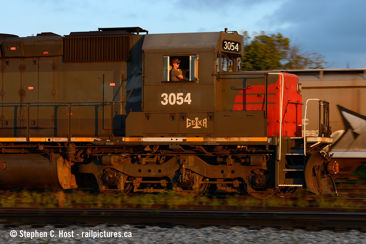 The Engineer has his movement safely under way as GEXR 518 switches cars in Kitchener yard. The sun has mere minutes left to shine as the solar terminator is about to arrive, bringing with it the familiar darkness of nightfall.