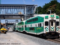 The new and the old - the New GO Station, officially called "West Harbour" and the old GO train - yes, that's right, this train is already old - all old paint - and an ageing cab car up front. The truth is, this photo will be even harder to get one year from now when more and more 'new scheme' GO cars are released.. and lets not forget the new cab cars too..<br><br>
What was interesting - even though I made fun of GO and Metrolinx for rushing this station so badly for the pan am games - what you see here is GO 573, which parked here for the afternoon, and in the far distance, you see GO 571 parked in the yard on the other side of the new signal bridge. Both of these trains were for the pan-am soccer (Football) event and both trains combined, had about 1500 people on board - the mass of people coming out of these trains was nothing short of a 'wow, they were right' moment. <br><br>
I was hoping to replicate John Eull's <a href=http://www.railpictures.ca/upload/go-559-pulls-out-of-the-old-cn-station-in-hamilton-bound-for-toronto target=_blank>Hamilton GO photo</a> from 1991 but with a 12 car train, the engine hangs out west of Stuart St... if they build a connection back to the Oakville through where I'm standing, it may be possible... in a few more years.


