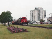 N 4135 has just crossed Bayfield Street with a single tank car bound for Stepan Canada in Longford Mills. This portion of the Newmarket Sub was lifted in 1996. Longford Mills is now serviced out of Huntsville and Wayne Shaw gets to take photos of it. One nice thing about the Newmarket Sub wrapping around Kempenfelt Bay was that if you heard a train you usually had time to get to a place to see it. My Blue 86 Honda Civic is to the right of the train, so I must have made a quick trip from the office. With the exception of the condo building, everything has changed. 