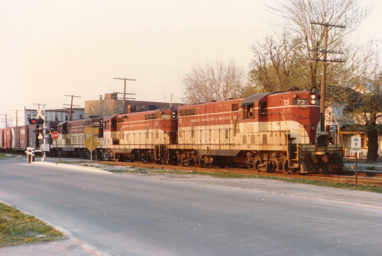 Wandering around in Niagara Falls one night a long time back, hoping to hear of the Chessie coming over, I was positively shocked to see TH&B power. Was able to grab this shot just after it entered Canada, but due to traffic (and traffic lights) there was no way I was going to beat this thing to Clifton Hill. So this was as good as it got. It was my understanding this train was usually after dark, and for once, it was early. Power is TH&B 73, 71 and 77. The streets here have all been realigned since then, but it used to be Elizabeth Pl alongside and Huron St crossing the train is going thru. Almost close enough to be street-running.:o)