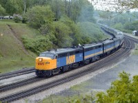 I sure miss these beautiful passenger trains. Just another example of how governments and their policies can kill anything. Typical dinner hour VIA #75 of the day passing thru Bayview. VIS 6777, 6868, 6619 and 6618 with the usual long train as seen on a hazy overcast eve. I suspect that 'pathway' up and down the hill on the left was made mostly by railfans scurrying around for the best photo angles. Once upon a time this area was wide open. Now, it is off limits.
