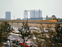A 7 coach Turbo Train is exiting Toronto Union Station on the way to the Spadina Avenue roundhouse on a gloomy overcast fall 1976 afternoon. It is almost nose-to-nose with the painted mural at the base of the CN Tower featured in one of my earlier submissions. Note the nose of the locomotive still sports the red CN logo applied during the transition from CN passenger service to the then new VIA Rail service.
39 years later, a sparsely populated lake front is no longer the case. The parking lot is also gone, giving way to construction of L'Hotel, the Metro Toronto Convention Center, and a new CN Regional Headquarters office building in the next decade. Once again my 76' Road Runner has snuck into the bottom of the frame.
My thanks to Dan Dell'Unto for having the patience, and for taking the time to correct this photo enough to make it acceptable to put on RP.ca