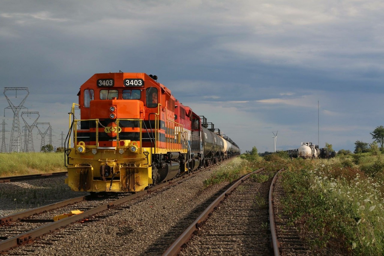 SOR train 597 with former CPR 5516 in the lead quietly sits at the north end of Garnet yard awaiting its evening departure to Paris. The train has spent the afternoon switching the industries at Nanticoke ( mainly the Esso refinery). A heavy rain storm has just rolled through the area with more to follow over the weekend.