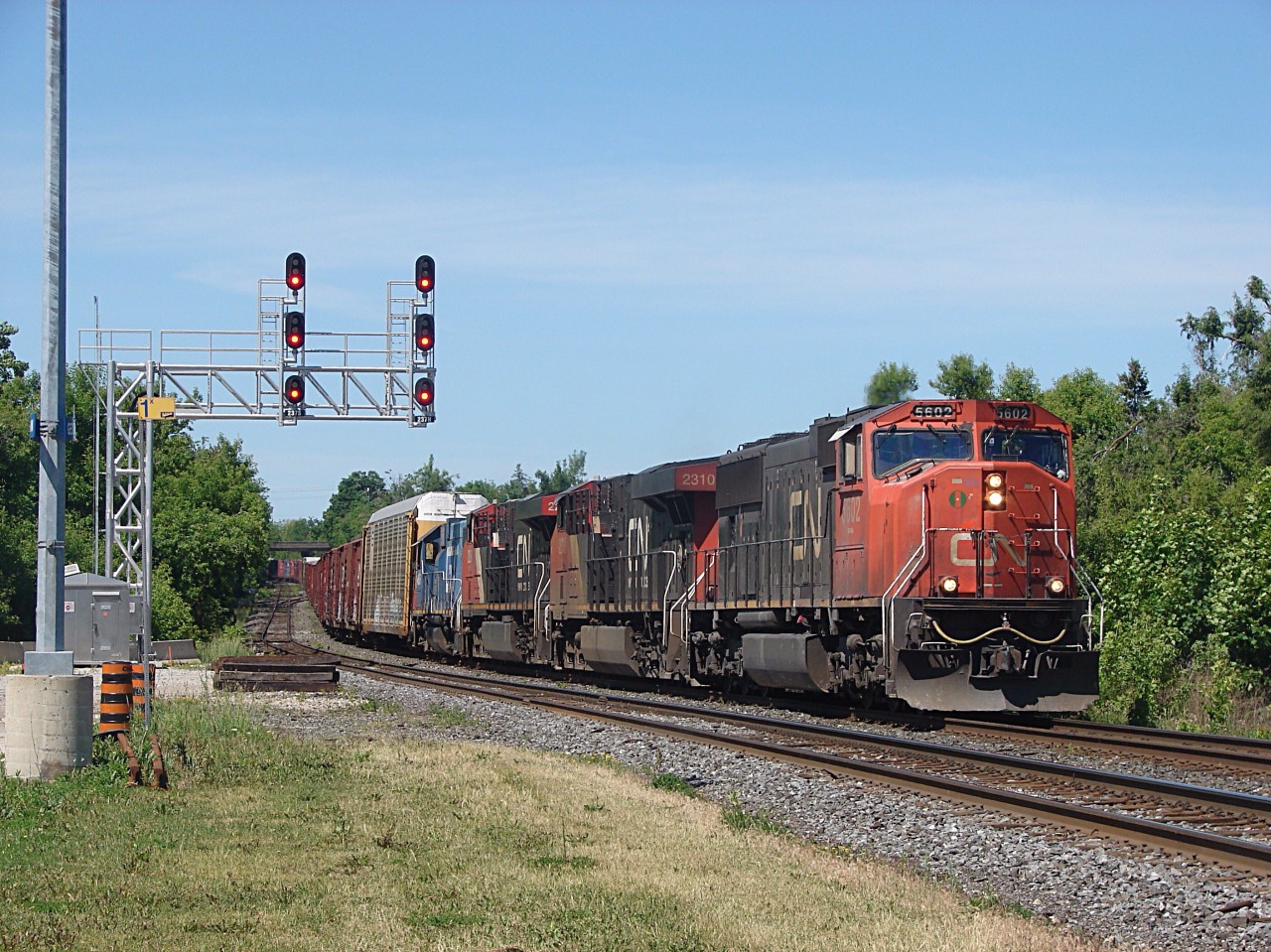 As the 4 unit lashup on CN M384 comes around the bend at CN Silver with a SD70i 2 ES44DC's and A GTW GP38-2!