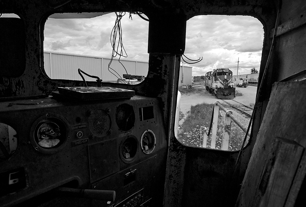 It's a gloomy day looking out from the former control cab, now a parts unit on the OSR. The work is done and a pair of Montreal built MLW's back down the water track for the barn at Guelph Junction.