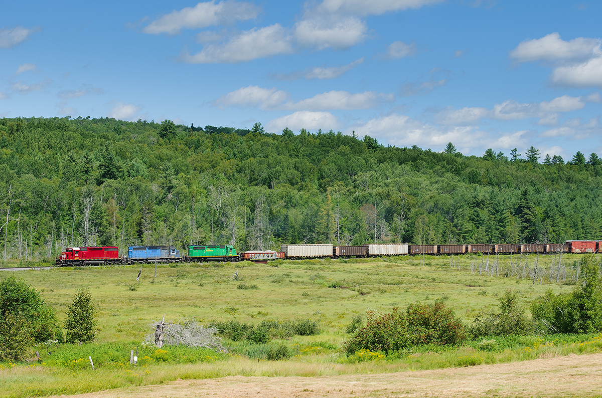 NBSR SD40-2s 6315, 6332 and 6200 head west on the McAdam Subdivision near Clarendon, NB with a 64 car train 907-14.