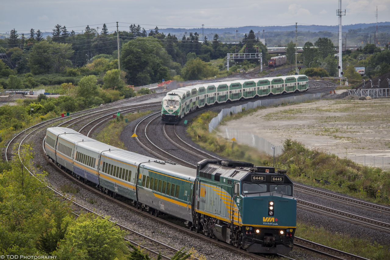 A busy day on the tracks! During rush hour on a summer's evening, Three Eastbound trains, VIA, GO Train, and CN, make their way through Whitby. 

VIA train 56 is bound for Montreal, GOT646 is bound for the Oshawa GO Station, and CN5743 is leading M372 which is also heading towards Montreal.