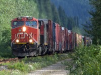 CN 2331 plays peek-a-boo with the sun as it climbs out of the valley to Blue River.