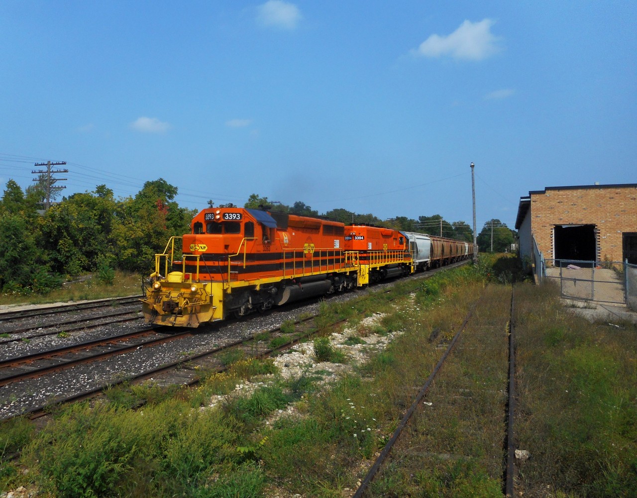 Hearing that 3394 was back from LDS in Sarnia  with orange paint, I headed out to catch it on it return from Toronto on it's first tour of duty.  Of course it was trailing.  Here, both of GEXR's SD40-2's 3393 and 3394 roll through Guelph with 54 cars.  The first 21 are salt cars for Goderich.  The rear 33 cars are auto racks, which will be set off at Kitchener for 516 to take to South Junction for the CPR.  And like many RP.ca photographers, I was out shooting 3394 the next morning.