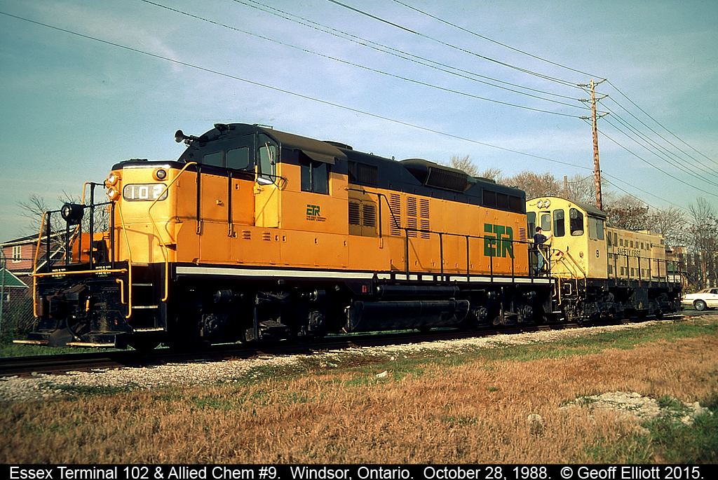 Essex Terminal GP9 #102, former Algoma Central #172 and the very LAST GP9 built by GMDD in London, leads Allied Chemical Alco S3 #9 back toward Amherstburg, Ontario back on October 28, 1988.  #9 had been in Windsor having work done at the Essex Terminal shops and is now heading back home to switch cars for Allied Chemical, but not before the crew stops to grab some 'beans' at the trackside MAC's Milk on Campbell Ave.
