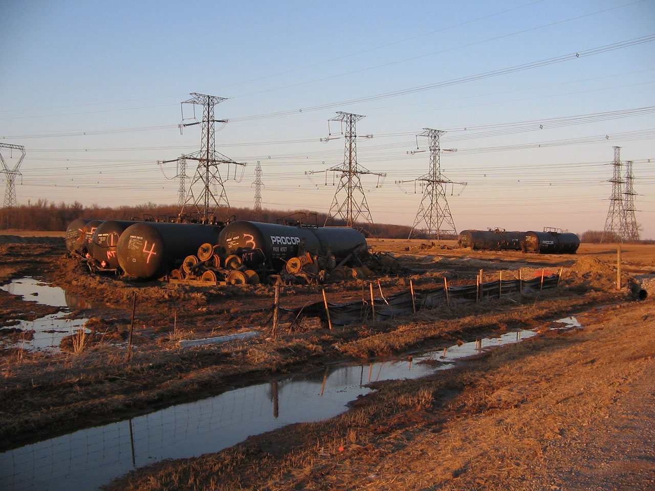 On thi cold and chilly March day, I was able to get some photos of the train derailment that happened in Nanticoke a few years back. Only these seven tankers remained with their trucks scattered about - all sitting in a famers field. The track was already repaired with fresh ballast. There was also some environmental concern, as evidenced in the ditches beside the tracks. This leads me to believe that the tankers were full when they derailed, although I don't know what or how this derailment was caused.