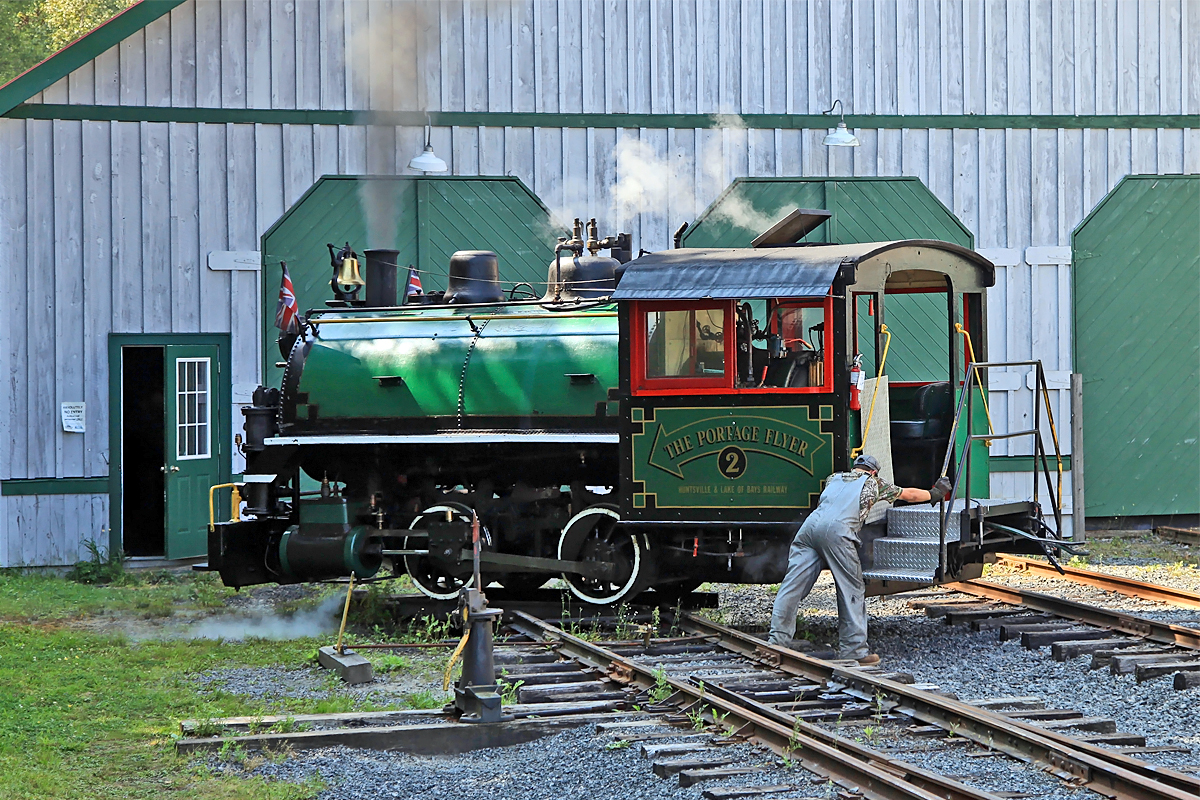 Fireman Cole spins the locomotive on the homemade mini-turntable in front of the train shed between runs in preparation for the next trip.