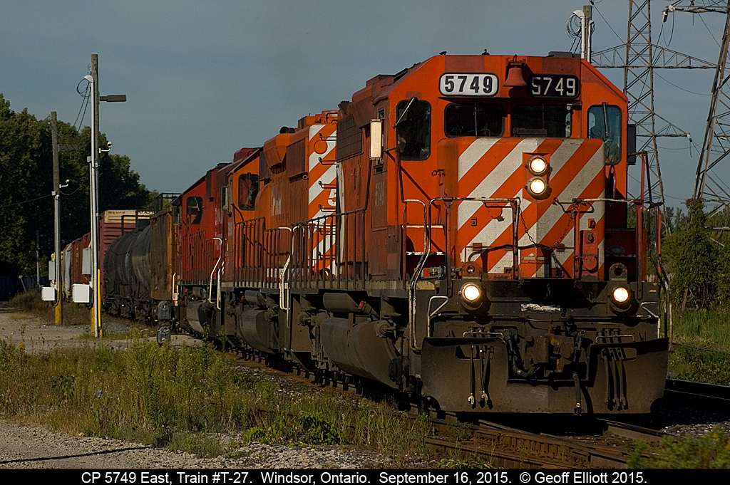 CP 5749, with it's mis-matched set of number boards, leads another SD40-2 and a rebuilt SD60 as it starts to roll away from Dougal Ave., in Windsor, Ontario on September 16, 2015.  T-27 has made one of it's trips to the U.S. to handle interchange traffic to/from CSX and NS and is now going to pull east of CP 'Lakeshore' to then shove their train back into Windsor yard to be re-switched.