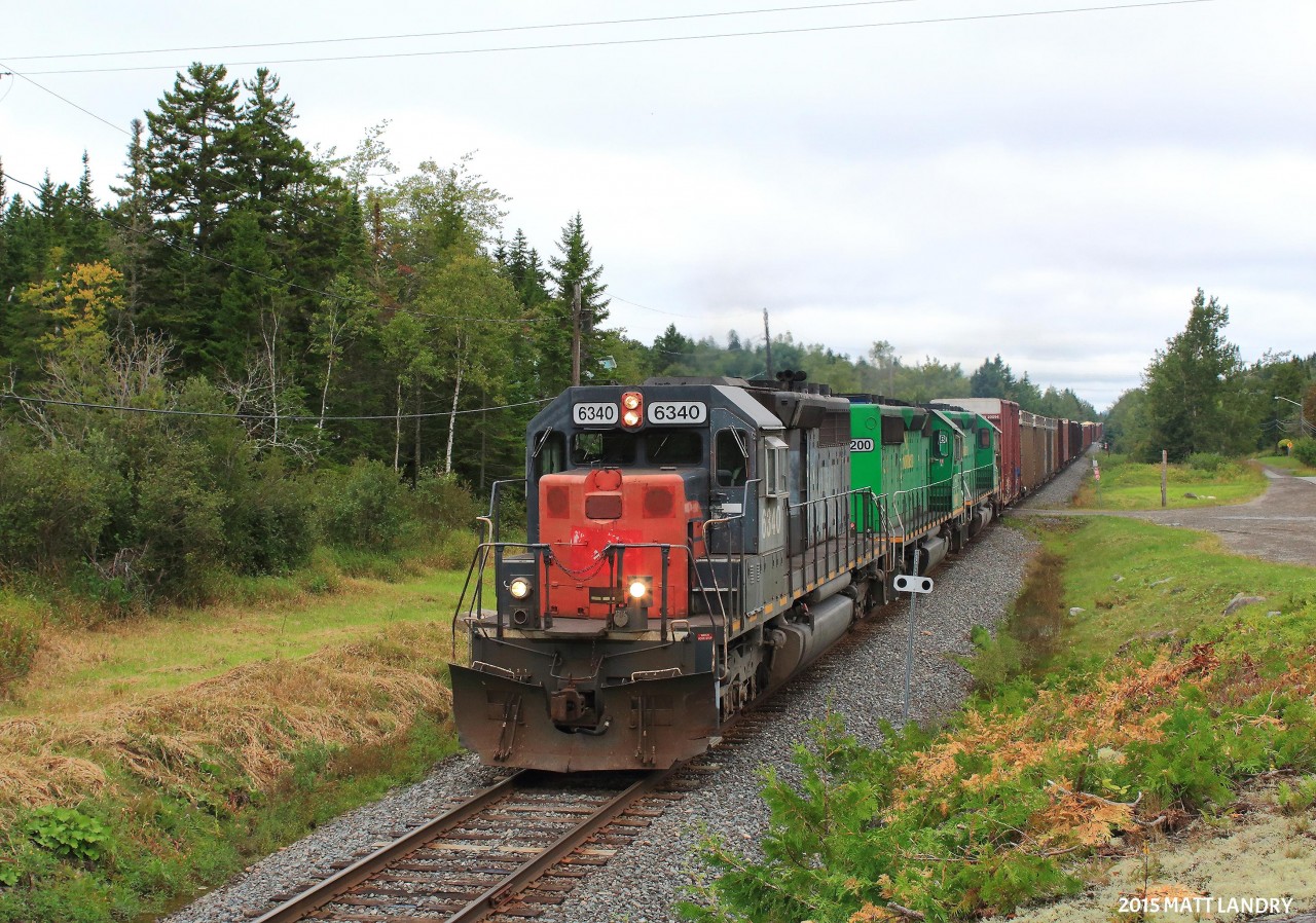 HLCX 6340, a former Southern Pacific SD40 leads a rare daylight New Brunswick Southern Railway eastbound mixed freight, approaching NBSR's Saint John yard limits. NBSR 6200 and NBSR 6318 are the other units, both former HLCX units, but that are now owned by the NBSR.