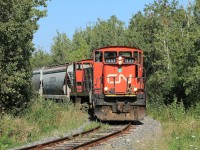 1444 and 1437 are about to cross Ford Drive on their way back to Oakville Yard with a couple of hoppers.