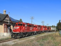 T07 slowly rumbles by the old CP station (now the Greater Peterborough Chamber of Commerce) with 17 cars lifted in Havelock.