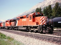 Four SD-40-2's spliced by GP-9 8663 have just crested the continental divide. Construction of the railway caused the creek here to have its path divided, hence the name Divide Creek. Half of the flow goes west towards the Pacific, the other half goes east. If you would like to change the world, you can take some water from one side and put it on the other.