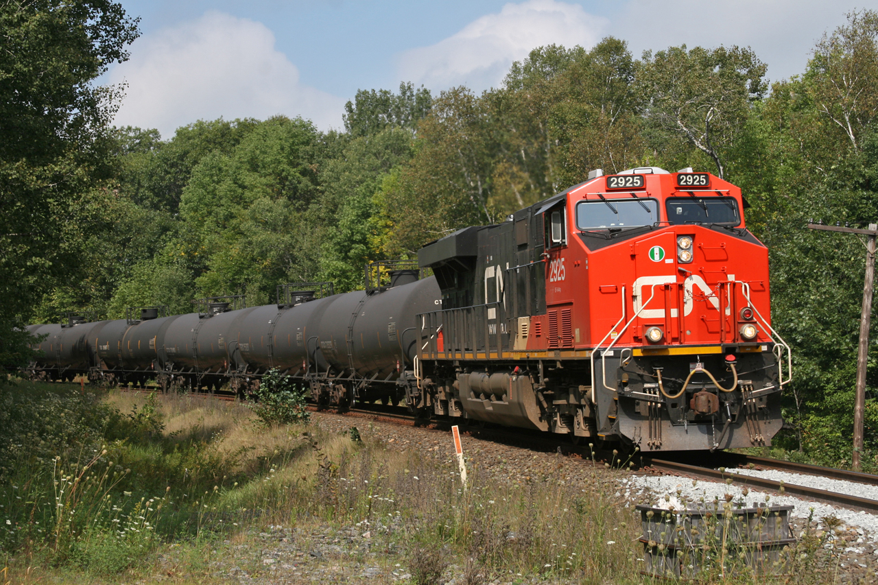CN 2925 has no trouble keeping this short unit train of tank cars at track speed (40MPH) as they wind through the curves and across James Bay Junction Road, calling a clear signal on the approach to Falding.  Just a few miles ahead, gravity will kick in as the solo ES44AC digs in to pull this train over the Falding grade and on to Medora for a meet with VIA No.1