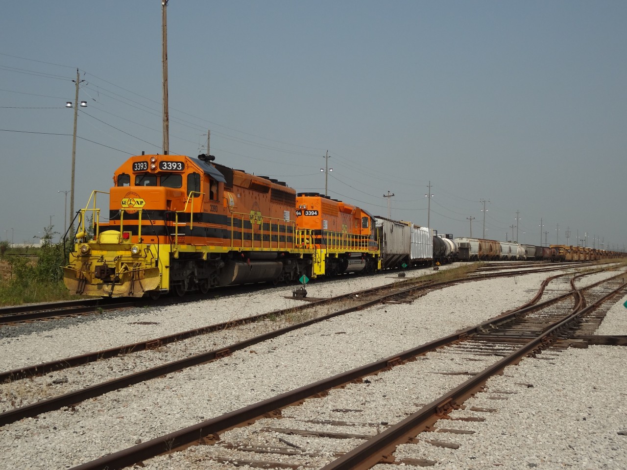 GEXR 3393 and her freshly painted sister GEXR 3394 have made up their train in L Yard at CN's Mac Yard in Concord, ON and are waiting for the rest of the crew walk up to the head-end before departing for points west.