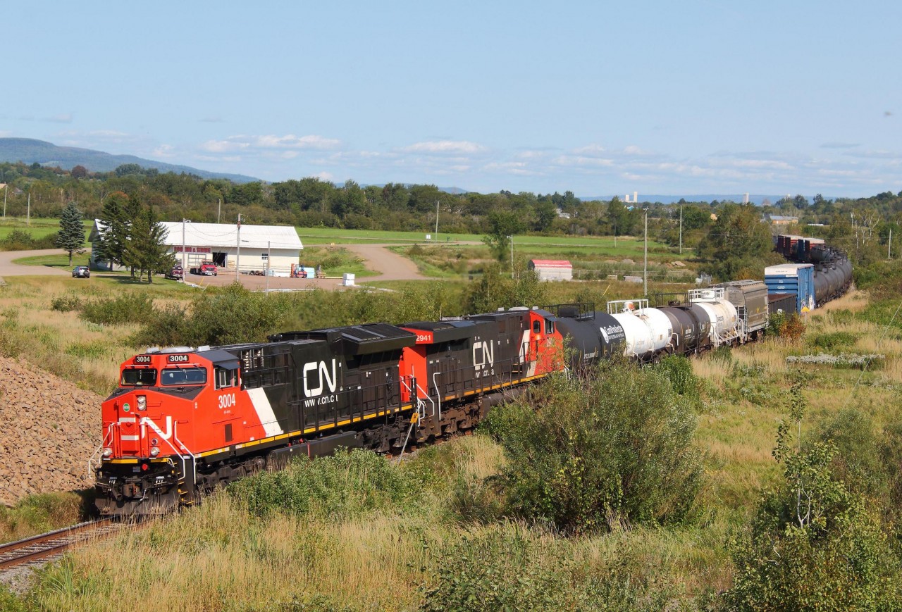 CN 3004 and 2941 lead a small 63 car westbound '406' train shortly after passing through the town of Sussex, New Brunswick. A new location for me to shoot, as this was taken hear the Highway 1 overpass. I was standing on the embankment, so no chance in getting run over.