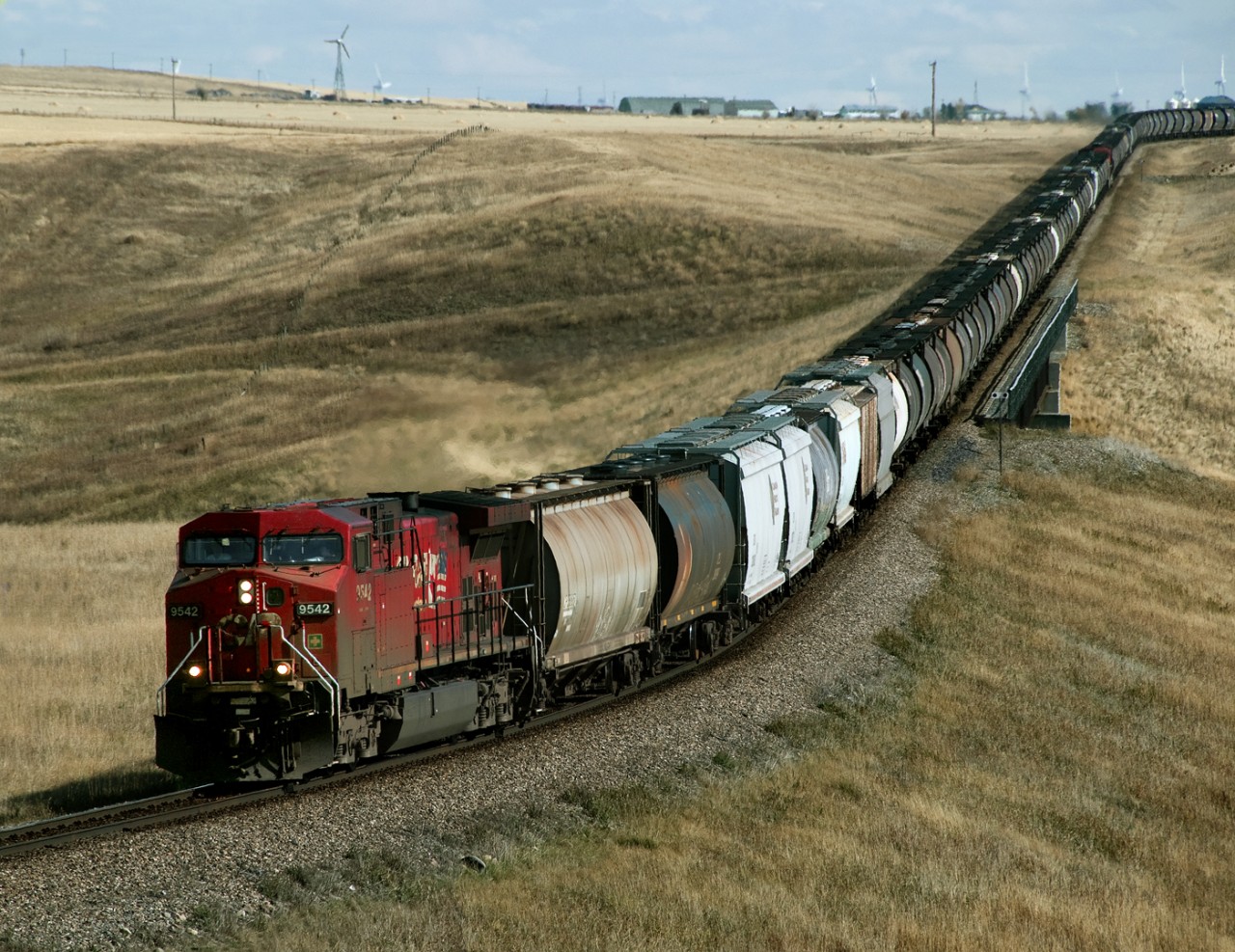 Westbound Grain train 355, Lethbridge to the Coast via Crowsnest and Golden, crosses the Castle River on a new section track built between Cowley and Pincher in the late 1980's due to the Oldman dam.