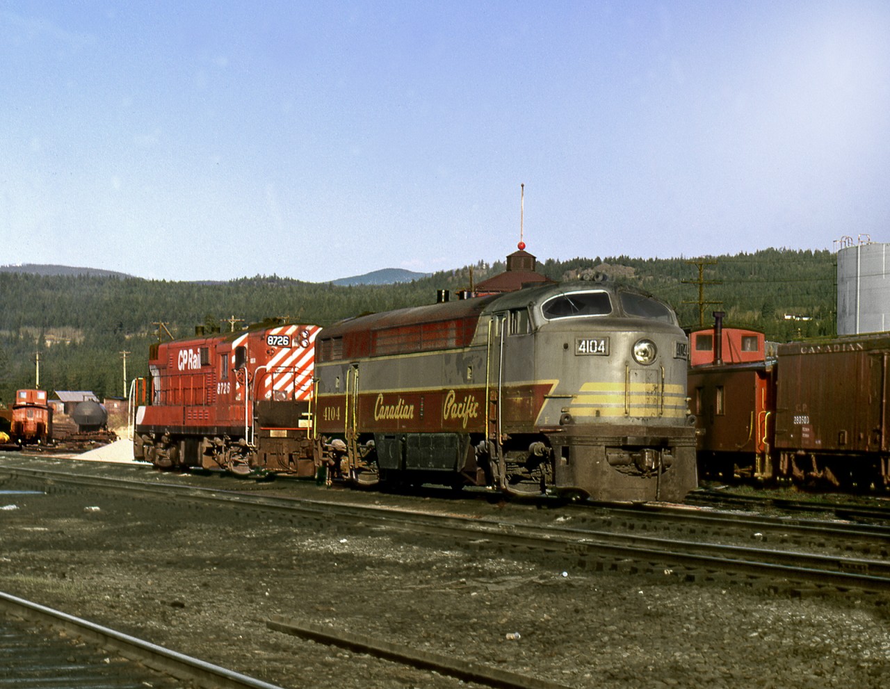 In the glory days of FM/CLC power on the Kootenay Division,C-Liner and H-Liner units sit at the east end of the yard on the ready tracks across from the station