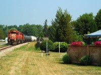 <b>A backyard Railway</b> in Chatham,  nearly five hours after departing Sarnia, D725 has arrived at what is "North Chatham" with 49 cars. North Chatham is the end of OCS limits and beginning of Yard limits, mile 19 Sarnia Subdivision and at this point, crews have to call the RTC to clear OCS limits and discuss with the Chatham Depot for their yarding instructions. <br><br>And here's another audio clip - from precisely this moment pictured - as the train is passing me and I'm taking photos, the crew discusses with Chatham Depot (Clerks name is 'Skip' Dunn) yarding instructions, then calls the RTC to clear South Chatham. <a href=http://steve.hostovsky.com/chatham07152005.mp3 target=_blank>Click here for the audio</a>