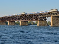 <b>I'm seeing double!</b> I was set up to shoot AMT 84 (on the closest track to me with RBRX 18531 leading) crossing the St-Lawrence river towards Montreal, and as luck would have it, a deadhead move towards the south shore was passing at the same time (with AMT 1342 pushing an identical consist on the next track over). 