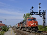 <b>GEVO and Dash9 leading.</b> CN 2264 & CN 2686 lead CN 368 past VIA's Dorval station on a warm and sunny morning.