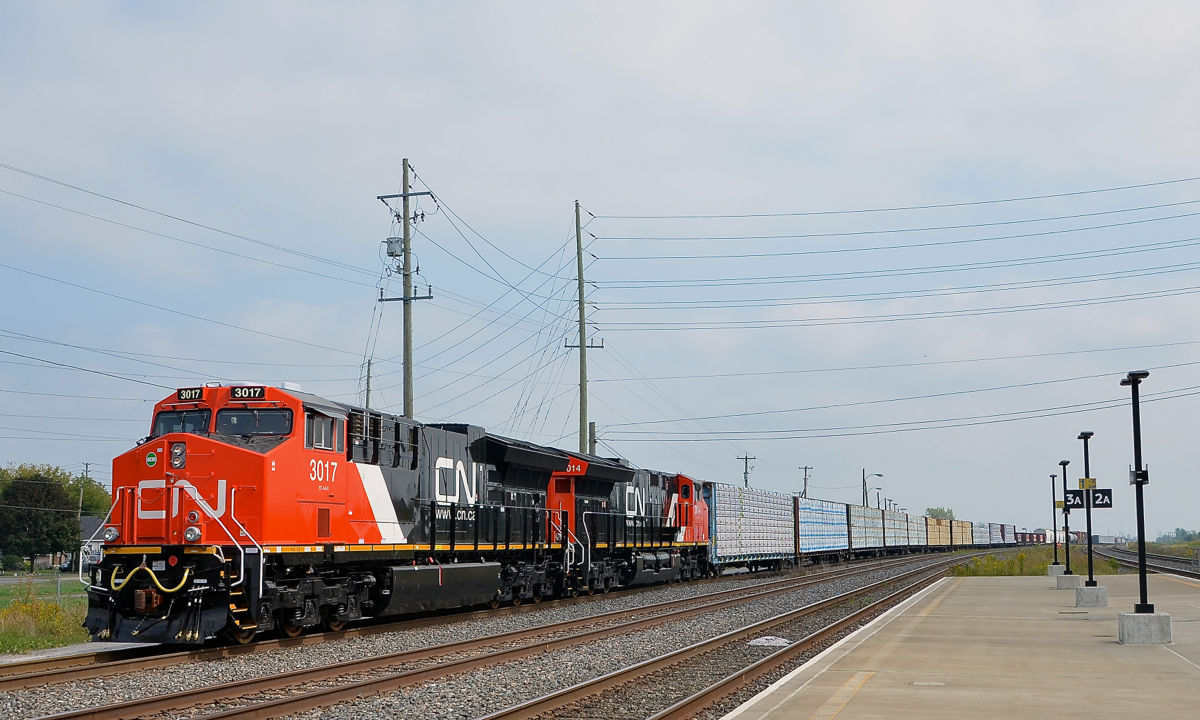 Delivered to CN just a couple of days ago, brand new ET44AC's CN 3017 & CN 3014 leave Belleville Yard with CN 369 after setting off some cars. They will follow CN 149 which left just a few minutes before.