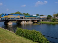 <b>VIA's last P42DC.</b> VIA 920 (VIA's last P42DC) leads a westbound over the Lachine canal on a hot summer afternoon as a couple passes under the train on a kayak.