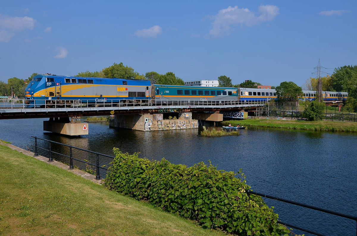 VIA's last P42DC. VIA 920 (VIA's last P42DC) leads a westbound over the Lachine canal on a hot summer afternoon as a couple passes under the train on a kayak.
