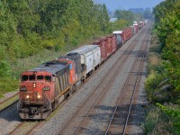 <b>Zebra cowl leading.</b> Zebra cowl CN 2416 & CN 5621 lead Montreal area transfer CN 527 towards nearby Taschereau Yard minutes after CN 401 passed.