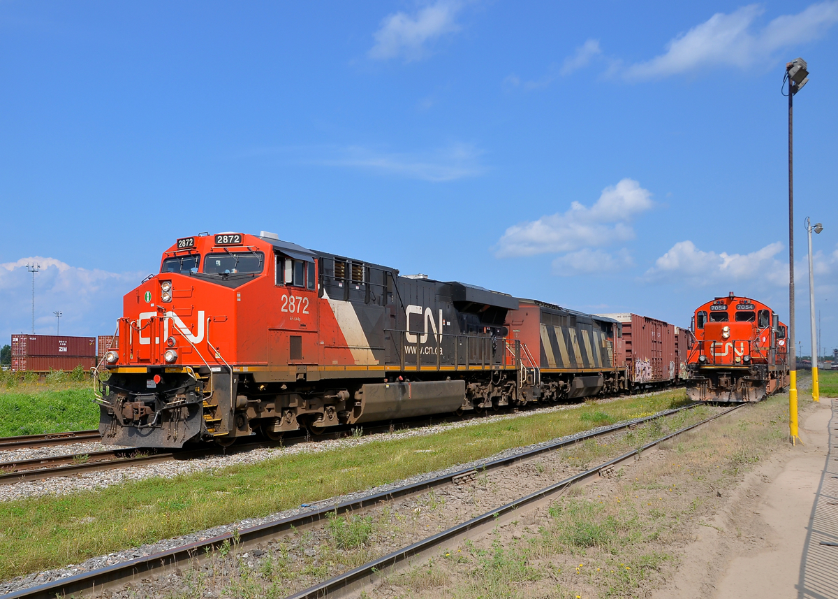 Revenue and non-revenue trains at Joffre. Three trains are seen at Joffre during the CN family day. In the middle is CN 309 (making its double) and at far left is CN 120 stopped for a crew change, both revenue trains. At right is a decidedly non-revenue train, with CN 7054 & CN 4139 taking part in beltpack demonstrations.