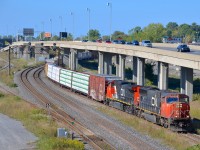 CN X324 has SD70I CN 5615 and surprisingly clean Dash9-44CW IC 2714 as it passes MP 6 of the Montreal sub.