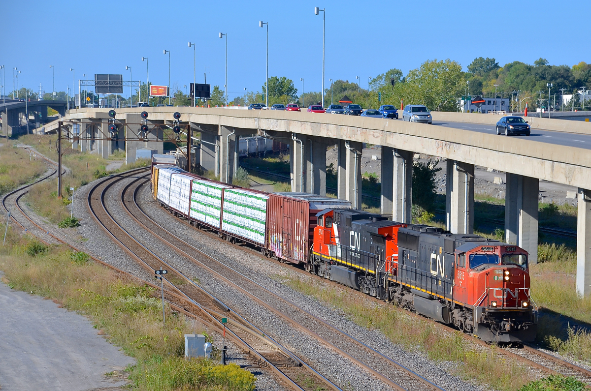 CN X324 has SD70I CN 5615 and surprisingly clean Dash9-44CW IC 2714 as it passes MP 6 of the Montreal sub.