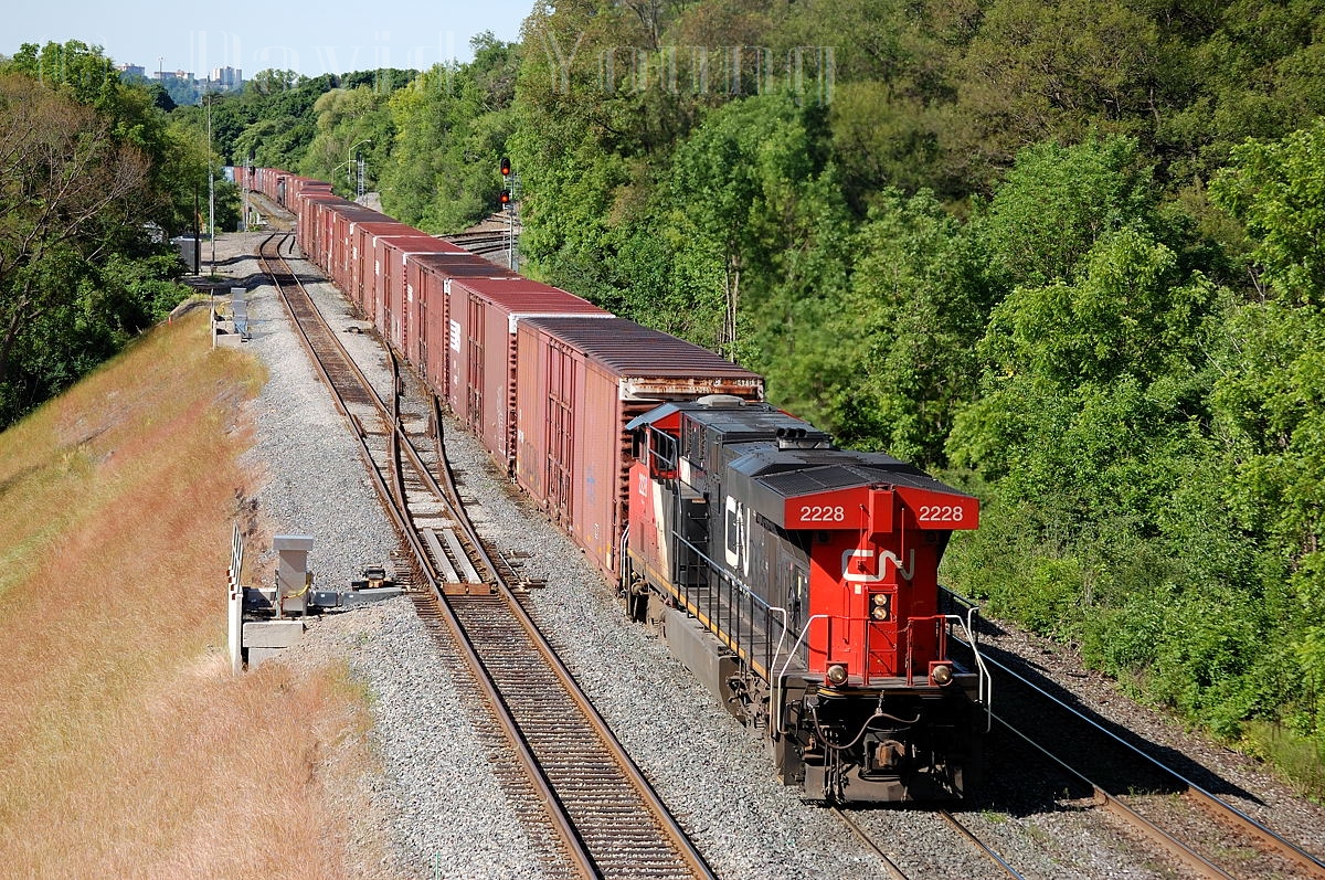 CN 2228 leads it's drag of auto boxes towards Aldershot and its termination point in Oakville. I don't recall many details about this train, but I believe it was strictly an autoparts train for Oakville, handled NS 327/8's traffic to Aldershot for a westward to lift and take to London. I don't believe this assignment lasted long either, anyone with info please feel free to fill in the blanks!
